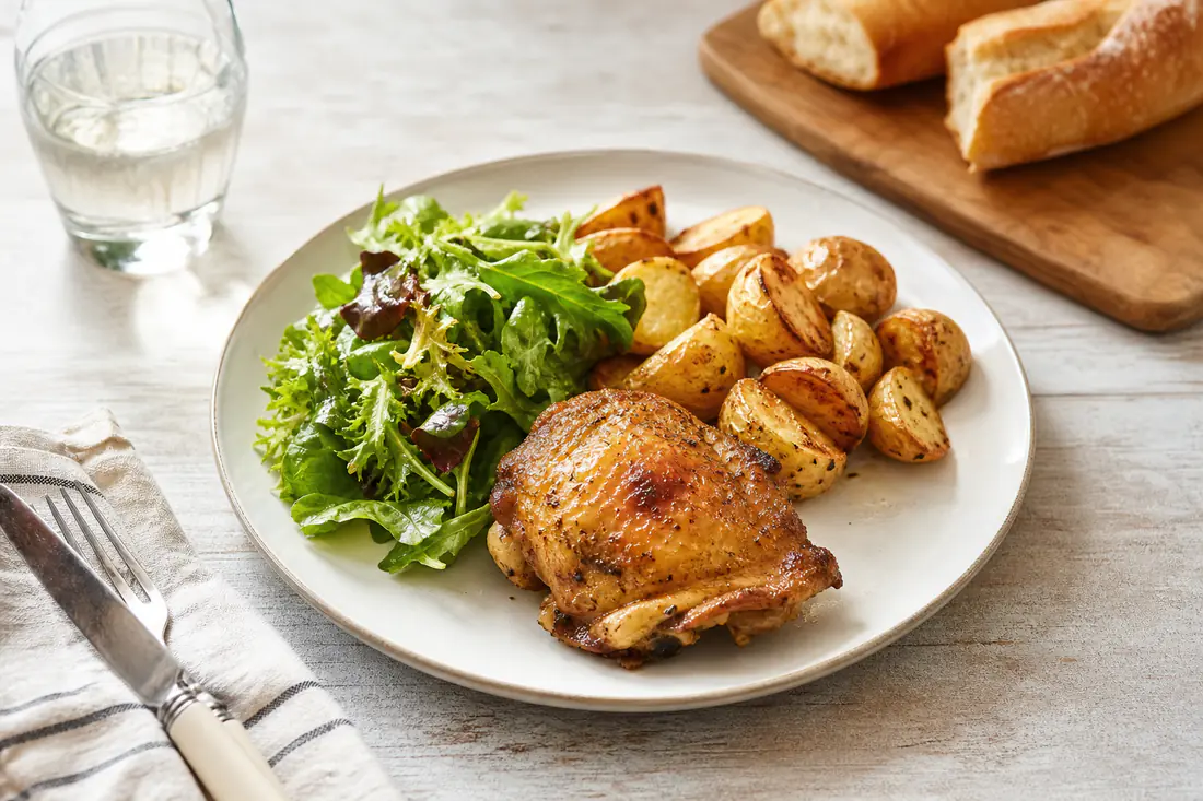 A weeknight dinner table with air-fried potatoes, roasted vegetables and a simple main dish
