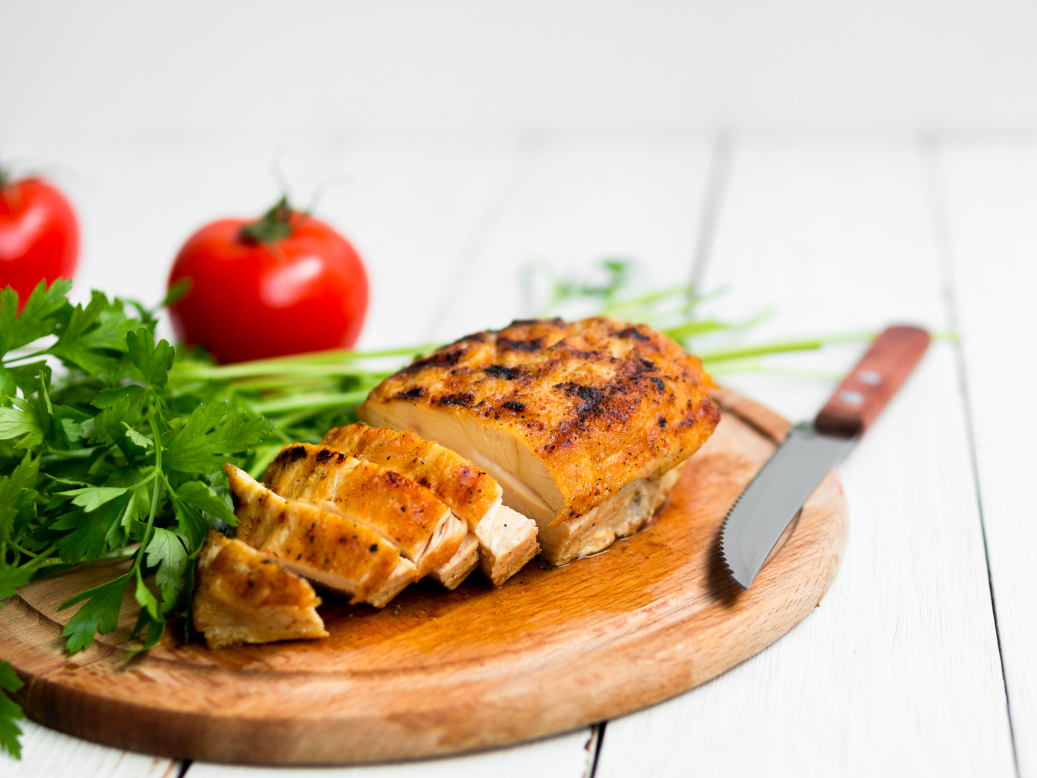 Crispy chicken fillet in air fryer served on a plate.