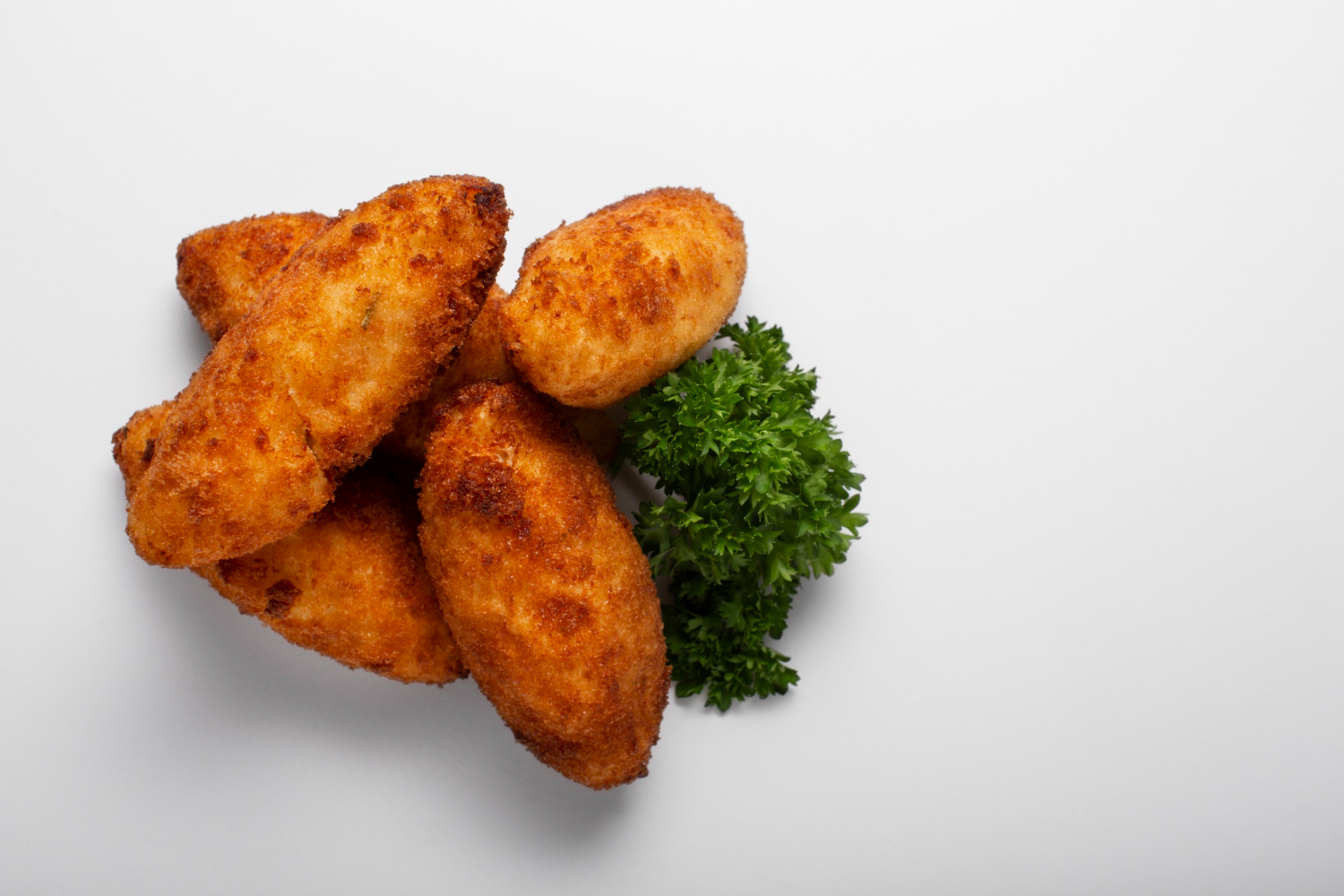 Crispy chicken nuggets in air fryer served on a plate.