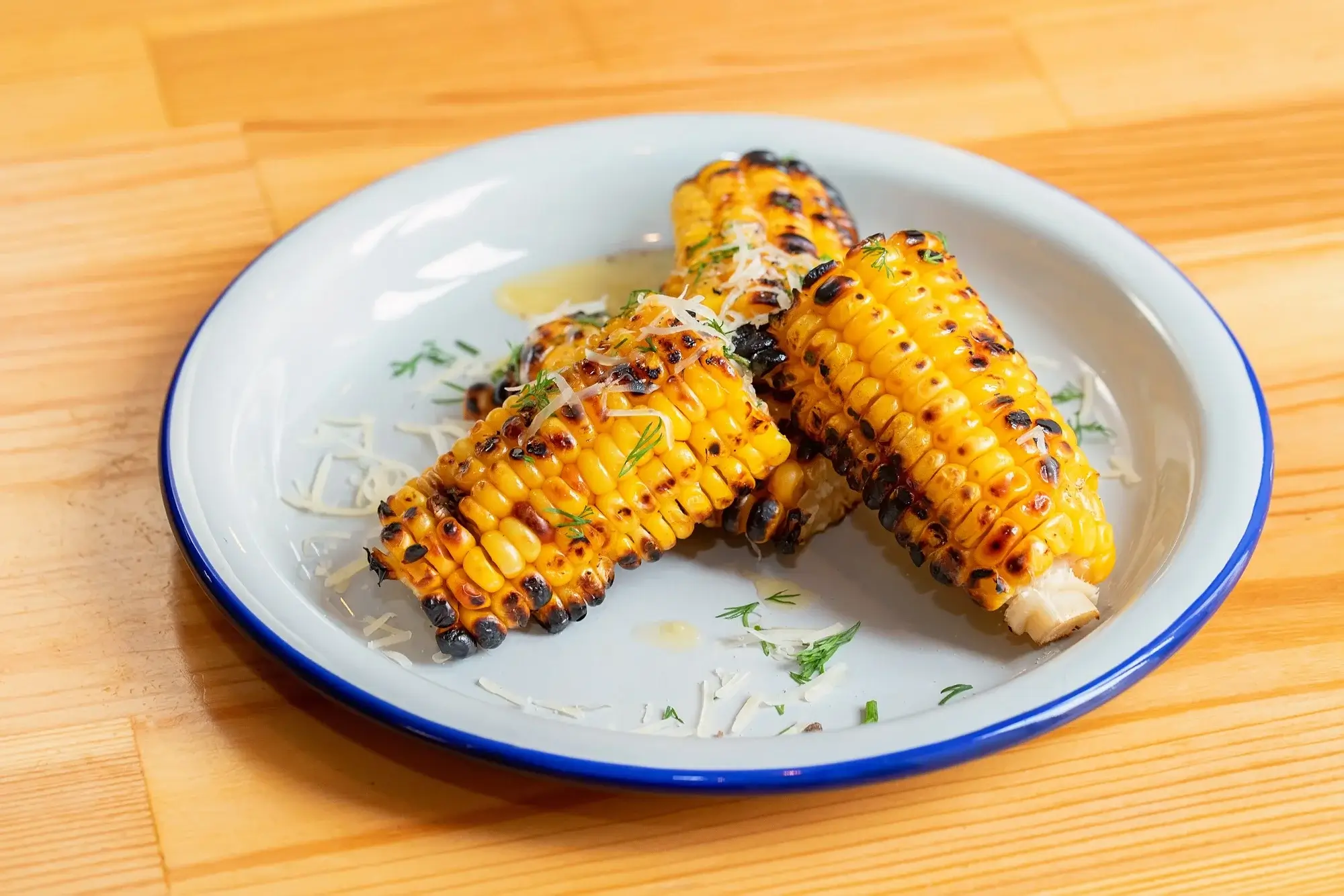 Golden-brown corn on the cob cooked in air fryer.