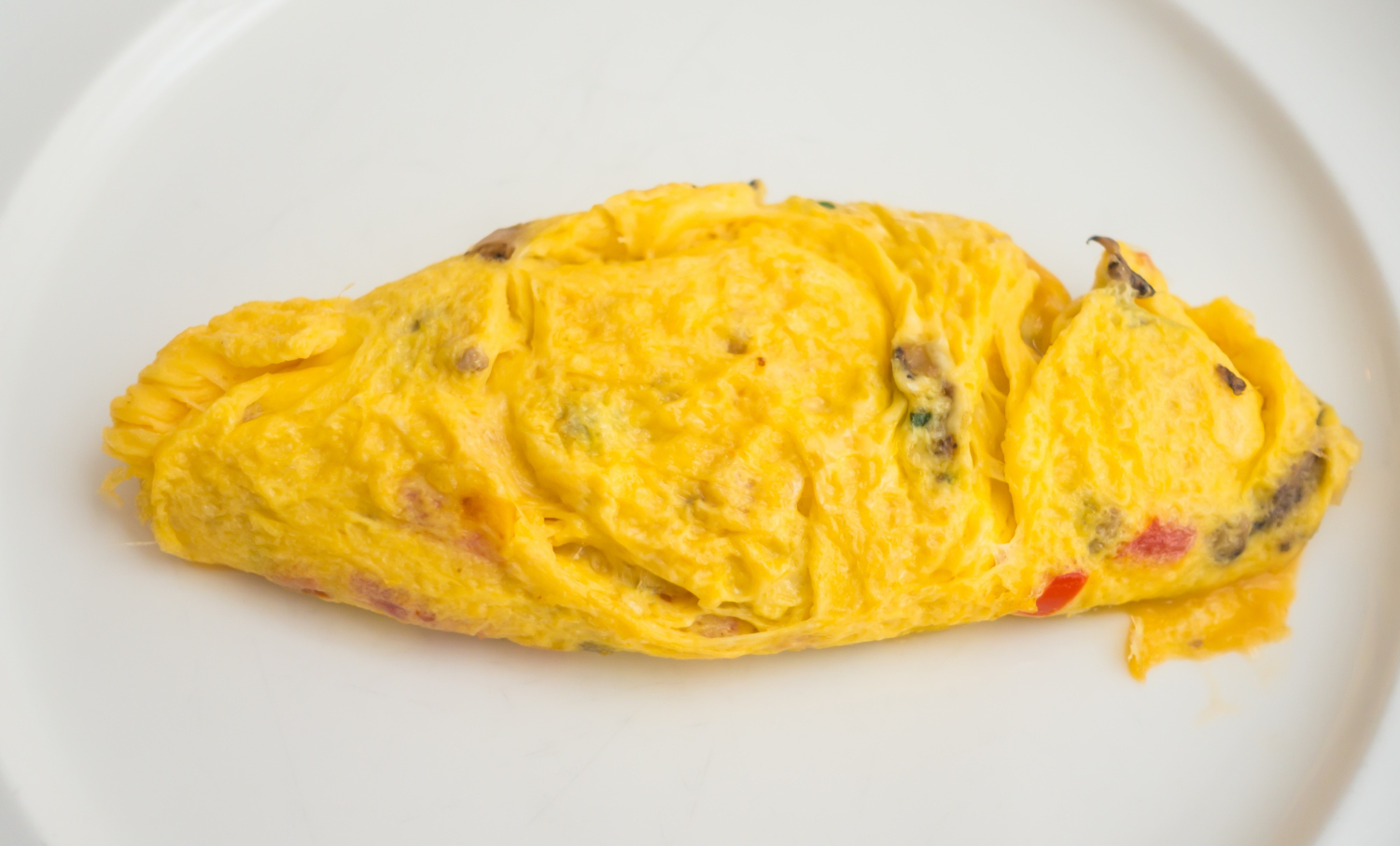 Fluffy omelet in air fryer with cheese and vegetables